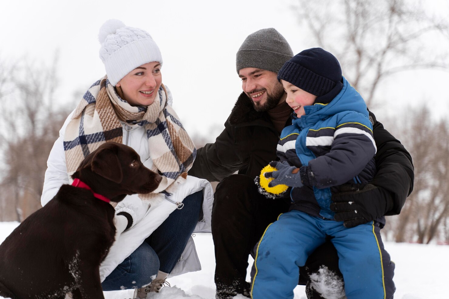 close up happy family playing snow with dog 23 2149103458